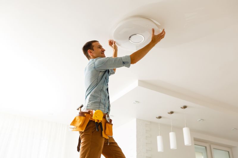 Handyman replacing a light fixture