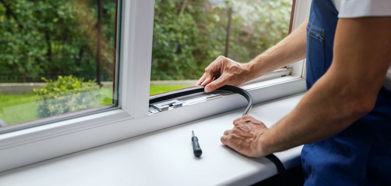 Handyman sealing windows