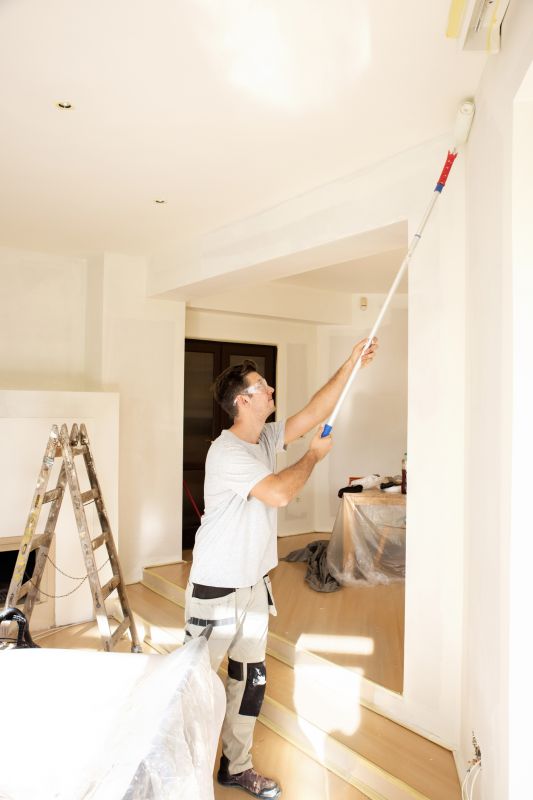 Handyman painting a ceiling